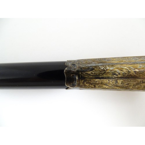 1118 - An early 20thC ebonised conductor's baton of tapering form with silver mounts engraved with foliate ... 