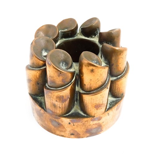 1136 - A Victorian copper jelly mould with twist turret detail. Stamped 358. Together with a brass pastry c... 