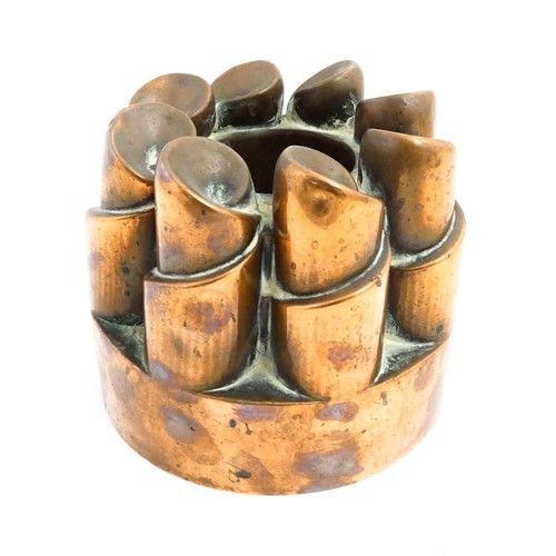 1136 - A Victorian copper jelly mould with twist turret detail. Stamped 358. Together with a brass pastry c... 