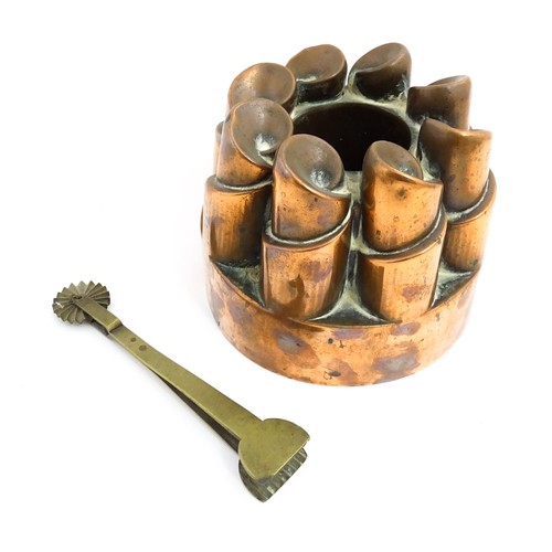 1136 - A Victorian copper jelly mould with twist turret detail. Stamped 358. Together with a brass pastry c... 