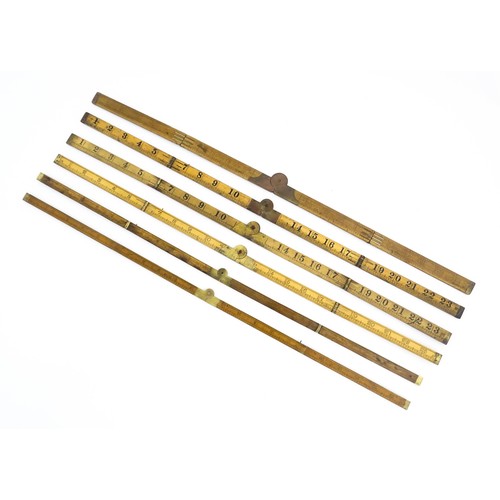 1202 - A quantity of 20thC boxwood and brass folding rulers to include examples by Rabone, Stanley Rule & L... 