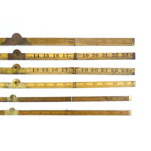 1202 - A quantity of 20thC boxwood and brass folding rulers to include examples by Rabone, Stanley Rule & L... 