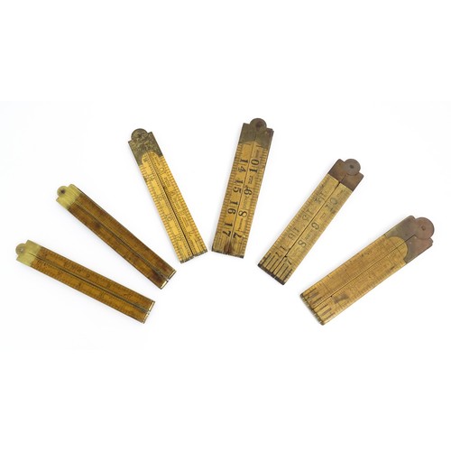 1202 - A quantity of 20thC boxwood and brass folding rulers to include examples by Rabone, Stanley Rule & L... 