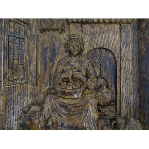 1266 - A late 19th / early 20thC relief carved oak panel depicting a Dutch interior with a woman preparing ... 