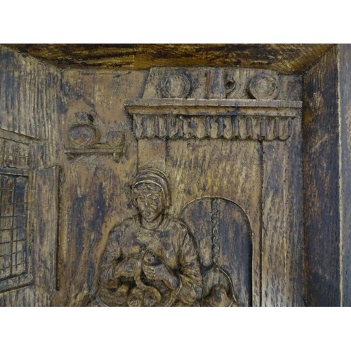 1266 - A late 19th / early 20thC relief carved oak panel depicting a Dutch interior with a woman preparing ... 