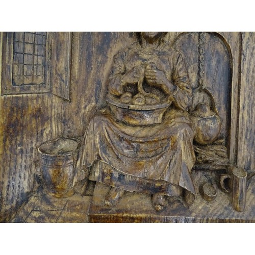 1266 - A late 19th / early 20thC relief carved oak panel depicting a Dutch interior with a woman preparing ... 