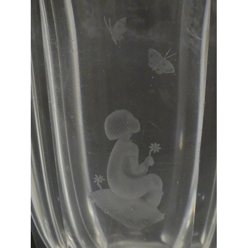 228 - Scandinavian art glass: An Orrefors glass vase with etched girl and butterfly detail. Signed under. ... 