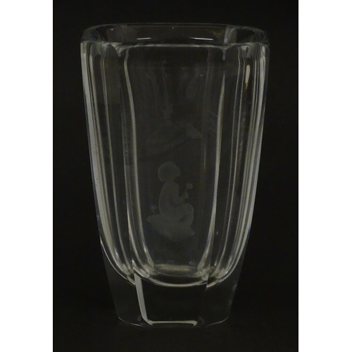 228 - Scandinavian art glass: An Orrefors glass vase with etched girl and butterfly detail. Signed under. ... 