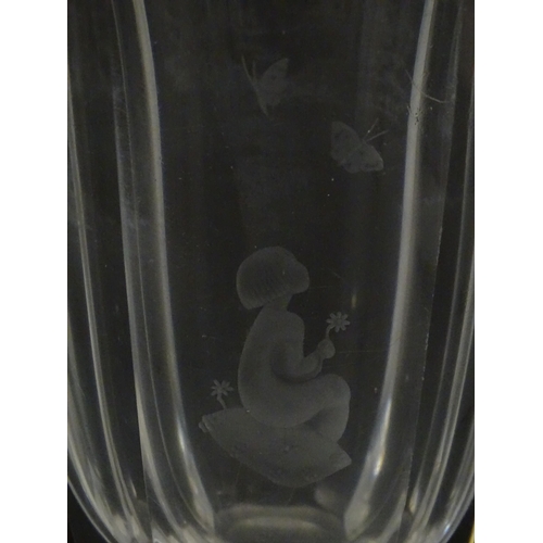 228 - Scandinavian art glass: An Orrefors glass vase with etched girl and butterfly detail. Signed under. ... 