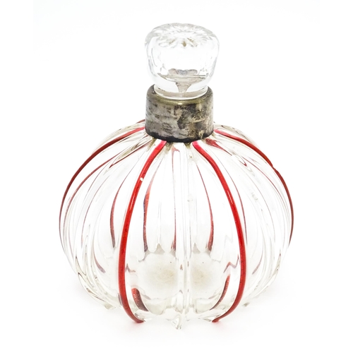 240 - An early 20thC glass scent / perfume bottle with red glass detail and silver collar hallmarked Birmi... 