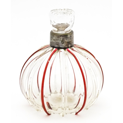 240 - An early 20thC glass scent / perfume bottle with red glass detail and silver collar hallmarked Birmi... 