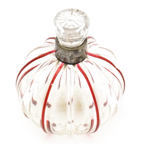 240 - An early 20thC glass scent / perfume bottle with red glass detail and silver collar hallmarked Birmi... 