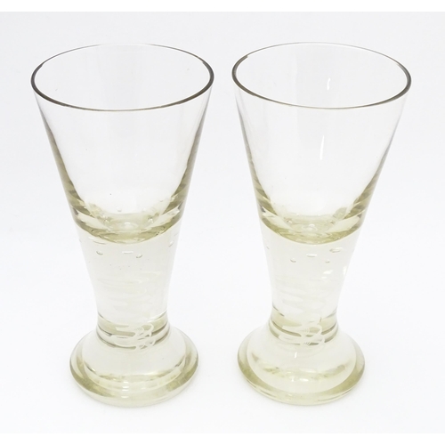 278 - A pair of drinking glasses with twist and bubble detail to stems. Approx. 7 3/4