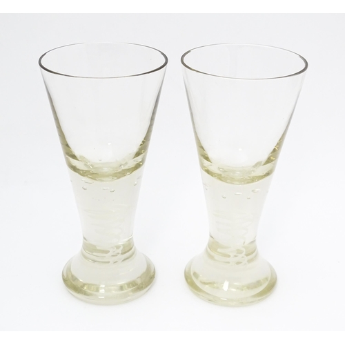 278 - A pair of drinking glasses with twist and bubble detail to stems. Approx. 7 3/4