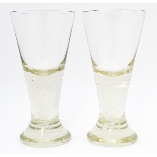 278 - A pair of drinking glasses with twist and bubble detail to stems. Approx. 7 3/4