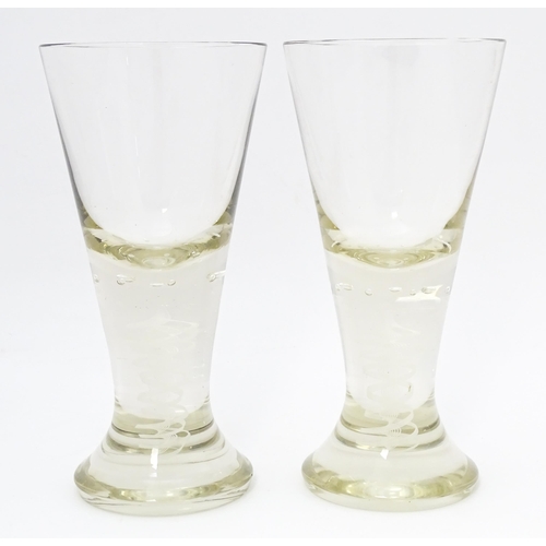 278 - A pair of drinking glasses with twist and bubble detail to stems. Approx. 7 3/4