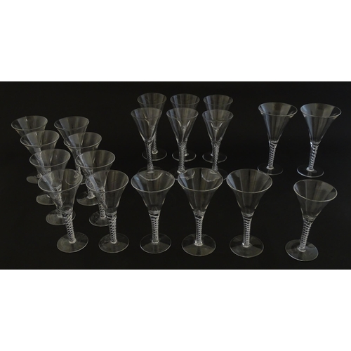 299 - A quantity of late 20thC drinking glasses with air twist stems, various sizes. Largest 6 3/4