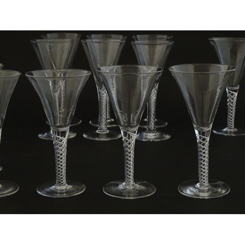 299 - A quantity of late 20thC drinking glasses with air twist stems, various sizes. Largest 6 3/4