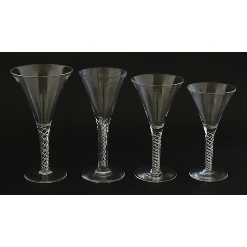 299 - A quantity of late 20thC drinking glasses with air twist stems, various sizes. Largest 6 3/4