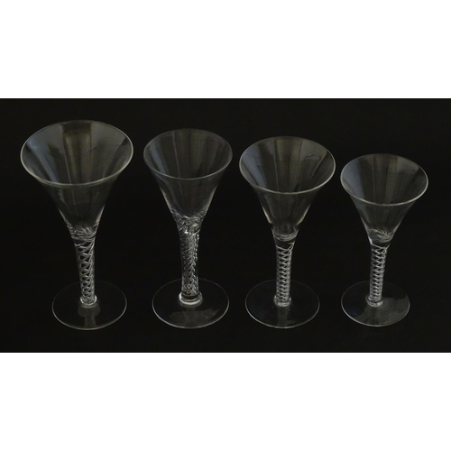 299 - A quantity of late 20thC drinking glasses with air twist stems, various sizes. Largest 6 3/4