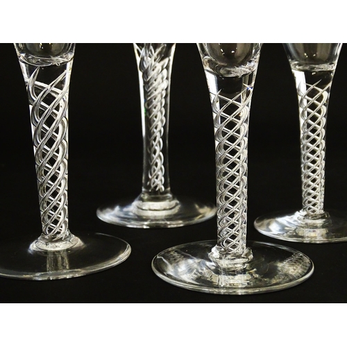 299 - A quantity of late 20thC drinking glasses with air twist stems, various sizes. Largest 6 3/4