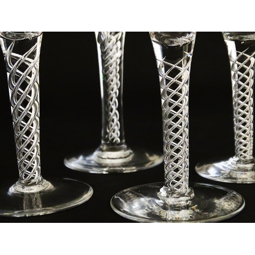 299 - A quantity of late 20thC drinking glasses with air twist stems, various sizes. Largest 6 3/4