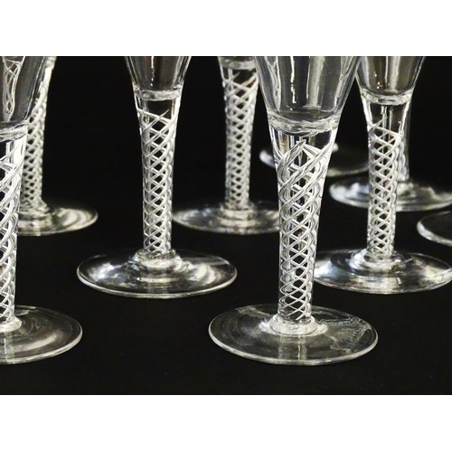 299 - A quantity of late 20thC drinking glasses with air twist stems, various sizes. Largest 6 3/4