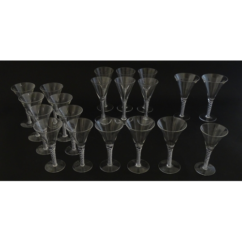 299 - A quantity of late 20thC drinking glasses with air twist stems, various sizes. Largest 6 3/4