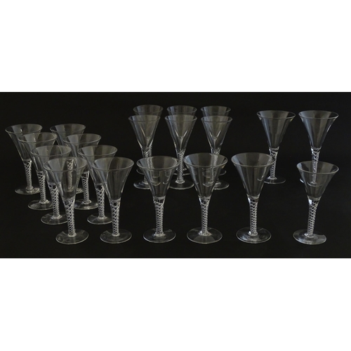 299 - A quantity of late 20thC drinking glasses with air twist stems, various sizes. Largest 6 3/4