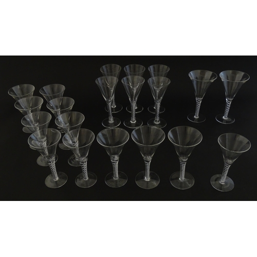 299 - A quantity of late 20thC drinking glasses with air twist stems, various sizes. Largest 6 3/4