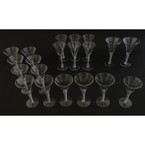 299 - A quantity of late 20thC drinking glasses with air twist stems, various sizes. Largest 6 3/4