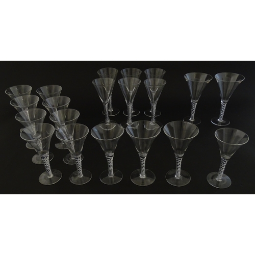 299 - A quantity of late 20thC drinking glasses with air twist stems, various sizes. Largest 6 3/4