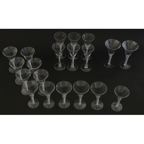 299 - A quantity of late 20thC drinking glasses with air twist stems, various sizes. Largest 6 3/4