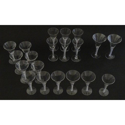 299 - A quantity of late 20thC drinking glasses with air twist stems, various sizes. Largest 6 3/4