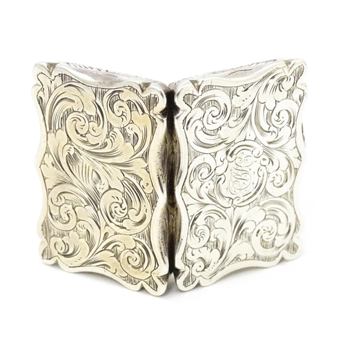 373 - A Victorian silver vinaigrette with engraved acanthus scroll decoration and opening to reveal a gild... 