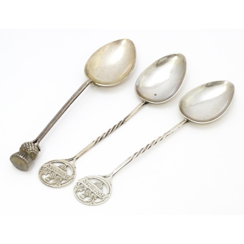 388 - A pair of silver Scottish souvenir teaspoons the handles with thistle detail and titled Braemar, hal... 