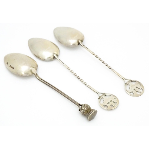 388 - A pair of silver Scottish souvenir teaspoons the handles with thistle detail and titled Braemar, hal... 