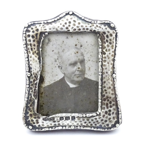 494 - Assorted items to include a miniature photograph frame with silver surround having hammered decorati... 