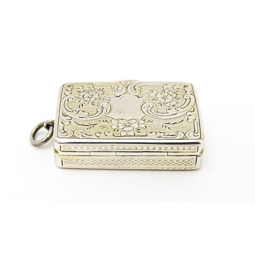 523 - A Victorian silver vinaigrette with engraved floral decoration hallmarked Birmingham 1857, maker Ast... 