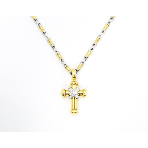 721 - An 18ct yellow and white gold necklace with cross formed pendant set with diamonds. Chain approx. 22... 