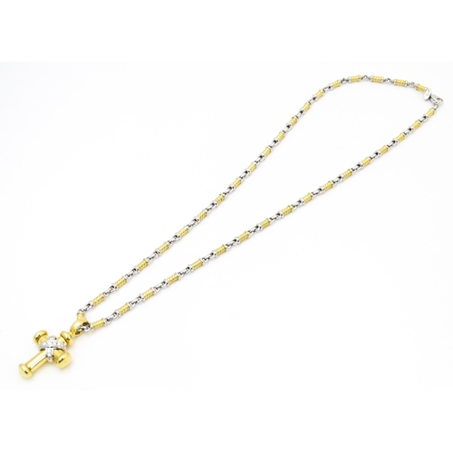 721 - An 18ct yellow and white gold necklace with cross formed pendant set with diamonds. Chain approx. 22... 