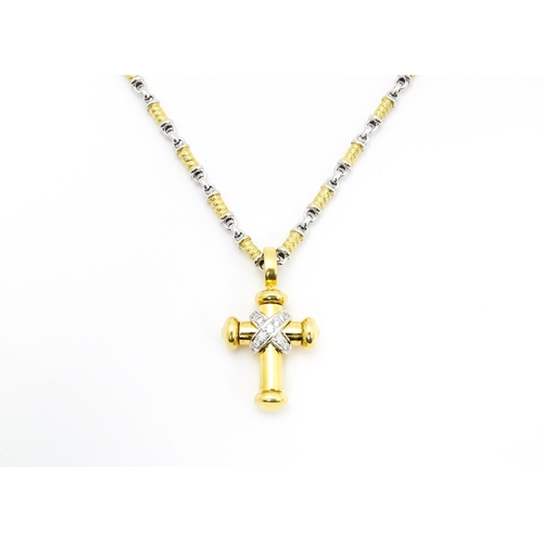 721 - An 18ct yellow and white gold necklace with cross formed pendant set with diamonds. Chain approx. 22... 