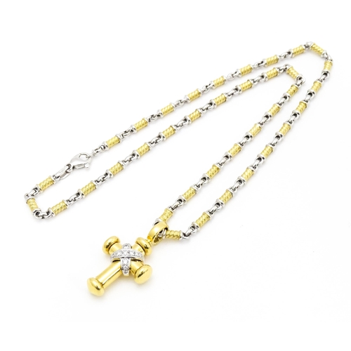 721 - An 18ct yellow and white gold necklace with cross formed pendant set with diamonds. Chain approx. 22... 