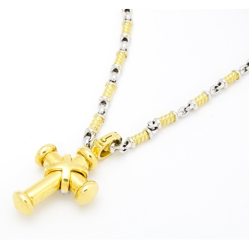 721 - An 18ct yellow and white gold necklace with cross formed pendant set with diamonds. Chain approx. 22... 