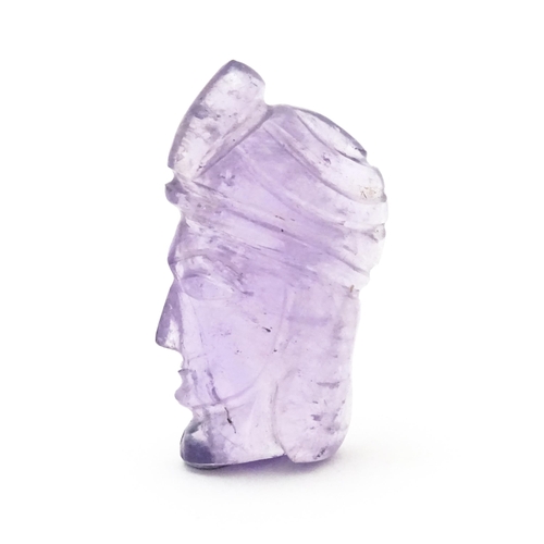 728 - An amethyst intaglio carved to form the head in profile of a man wearing a turban. Approx 1