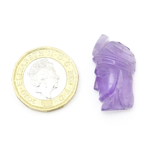 728 - An amethyst intaglio carved to form the head in profile of a man wearing a turban. Approx 1