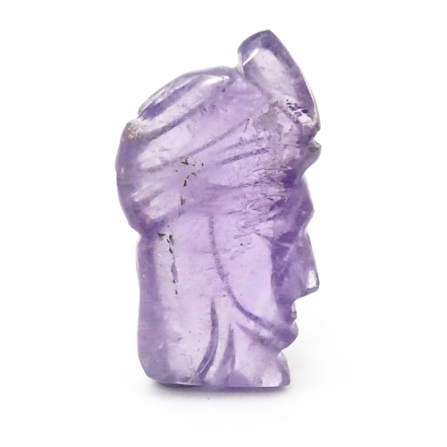 728 - An amethyst intaglio carved to form the head in profile of a man wearing a turban. Approx 1