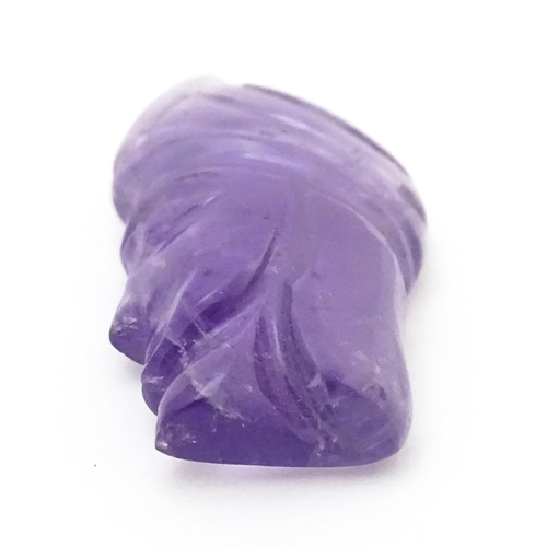 728 - An amethyst intaglio carved to form the head in profile of a man wearing a turban. Approx 1