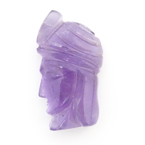 728 - An amethyst intaglio carved to form the head in profile of a man wearing a turban. Approx 1