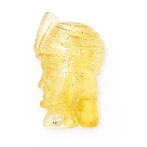 737 - A citrine intaglio carved to form the head in profile of a man wearing a turban. Approx 1